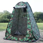 Green pop up privacy tent in a forest.