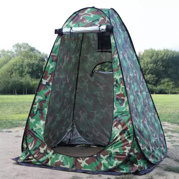 Green pop up privacy tent in a forest.