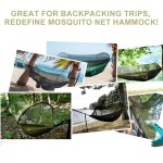 Automatic quick-opening camping hammock with mosquito net popped open in a forest.