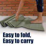 A traveler inflating the waterproof outdoor sleeping pad inside a mountain tent.