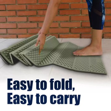 A traveler inflating the waterproof outdoor sleeping pad inside a mountain tent.