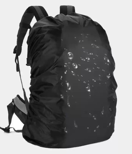 Black waterproof backpack rain cover shown fitted on a large 100L hiking rucksack in the rain.