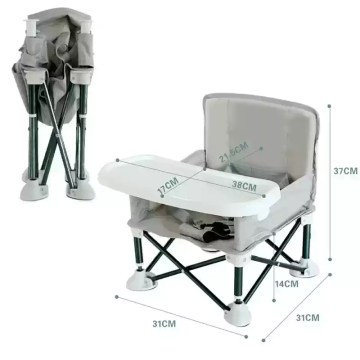 Baby sitting in a portable foldable camping high chair with safety tray, wearing sun hat and sunglasses outdoors, ideal for picnics, travel and family camping.