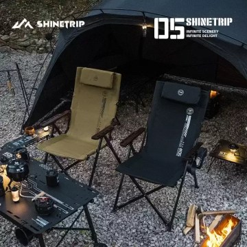 Two folding camping chairs set inside tent with outdoor table