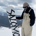 Side view of beige snowboard bib trousers with adjustable shoulder straps