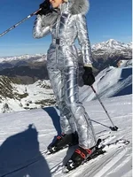 Silver Metallic Ski Suit Woman wearing a silver metallic ski suit on snowy slopes