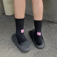 Black Knitted Crew Socks Black knitted crew socks worn with casual footwear for everyday use