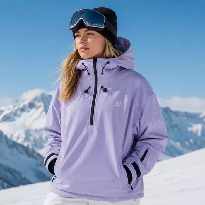Man wearing a white hooded ski jacket and black beanie in snowy mountains