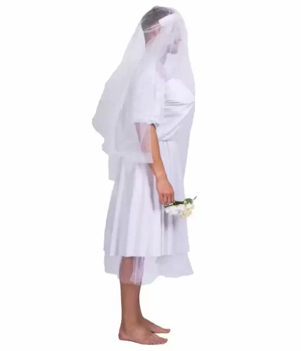 Side view of man wearing white bride costume with veil and bouquet.