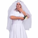 Funny man in bride dress covering mouth holding flower bouquet.