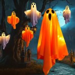 Hanging white and orange LED glowing ghost decorations in a spooky night scene.