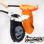 Close-up view of skeleton hand and orange claw hand Halloween trick-or-treat grabber bags.