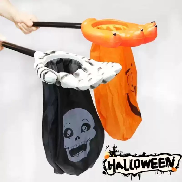 Close-up view of skeleton hand and orange claw hand Halloween trick-or-treat grabber bags.