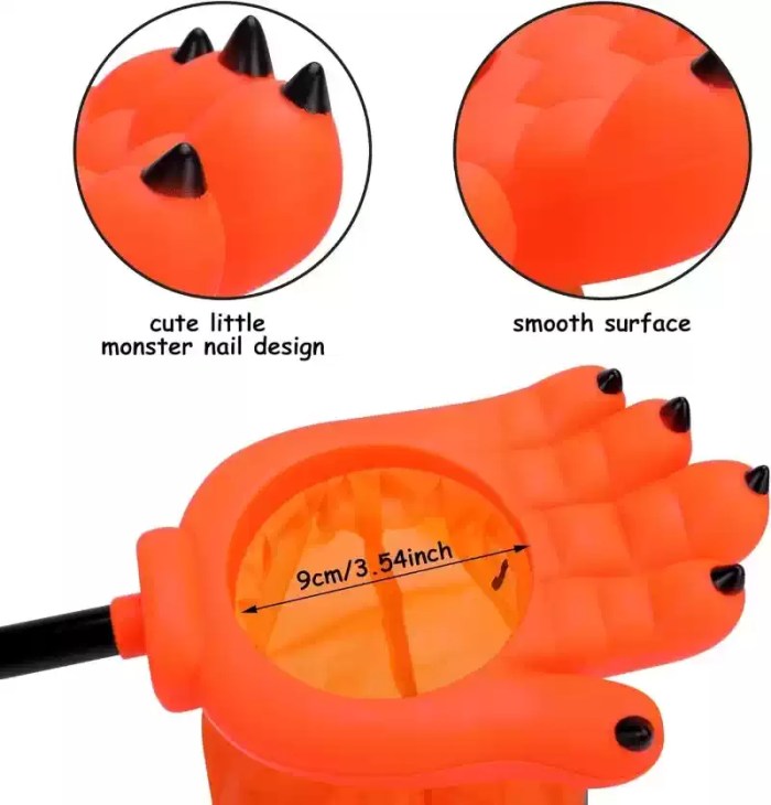 Detail view showing opening size and claw design of orange monster hand candy bag.