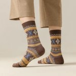 Patterned knitted winter crew socks worn with casual trousers