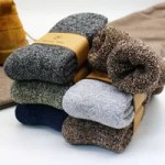 Folded thick wool socks in grey, blue, brown and green winter colours