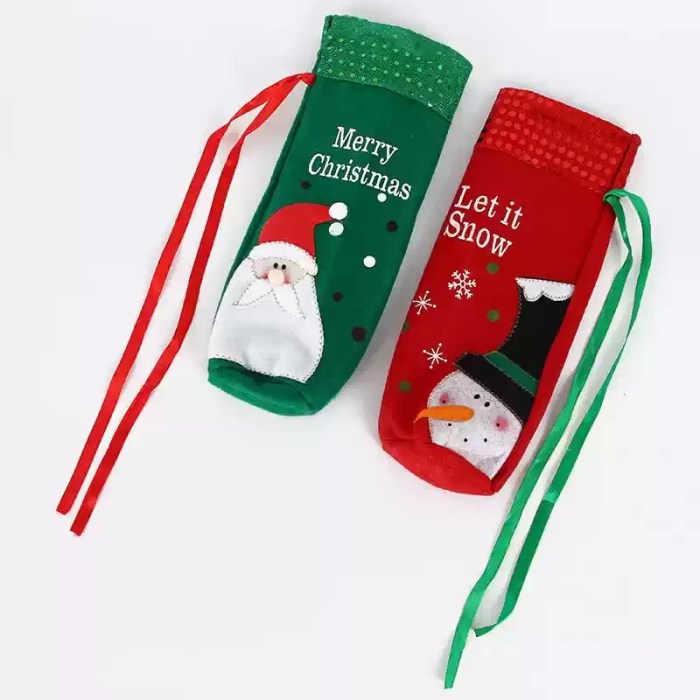 Red and green Christmas bottle gift bags with Santa and snowman designs and ribbon ties.