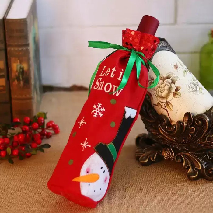 Red snowman Christmas wine bottle bag with green ribbon and festive Let It Snow design.