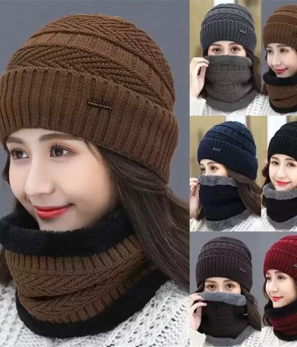 Women's brown cable-knit winter beanie and matching neck warmer set featuring a small woven tag worn by a model