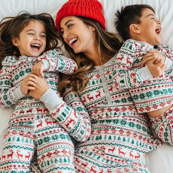 Happy family lying down in matching Fair Isle holiday pajamas