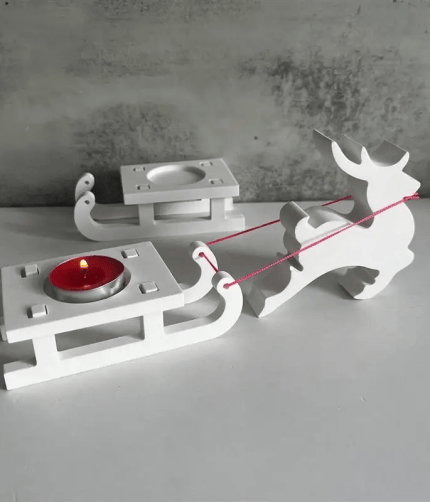 White reindeer and sleigh Christmas candle holder with red tealight.