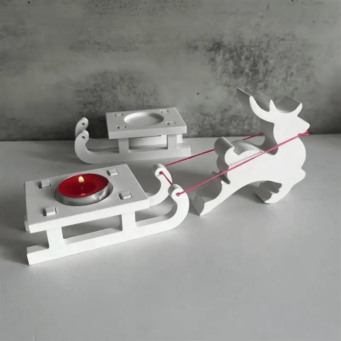 White reindeer and sleigh Christmas candle holder with red tealight.