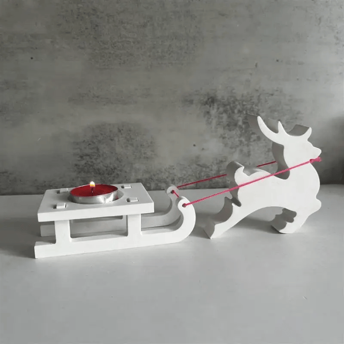 Christmas reindeer pulling a white sleigh candle holder with tealight.