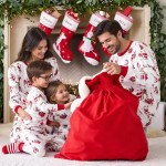 Family wearing matching Christmas pyjamas while opening festive gifts at home
