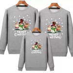 White matching family Christmas sweatshirts with festive character print.