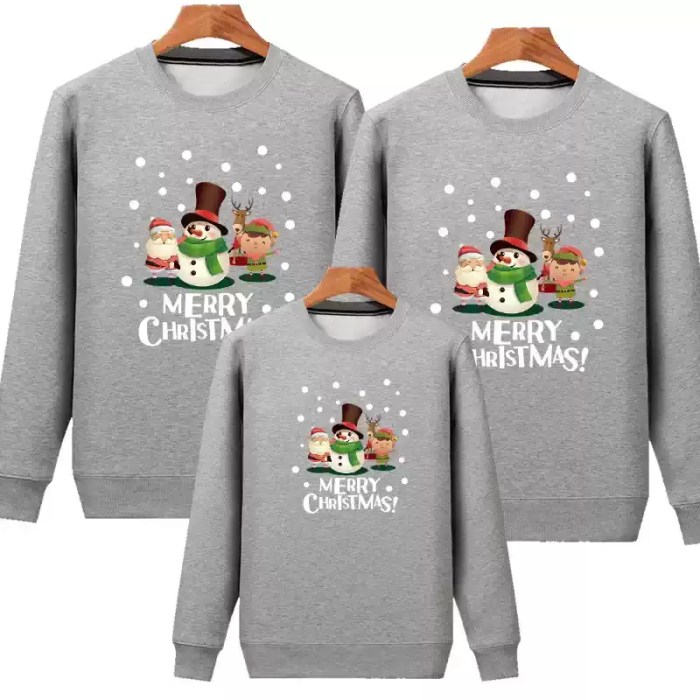 grey-family-christmas-sweatshirts.webp White matching family Christmas sweatshirts with festive character print.