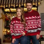 Man hugging woman from behind while wearing matching red reindeer holiday sweaters.