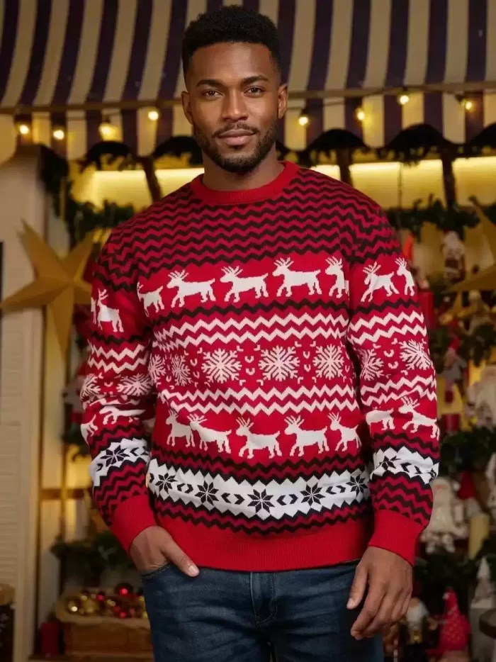 Man posing in a red and white knit Christmas sweater with reindeer and snowflake details