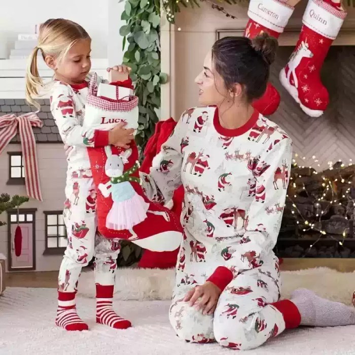 Mother and daughter in matching Santa pajamas.