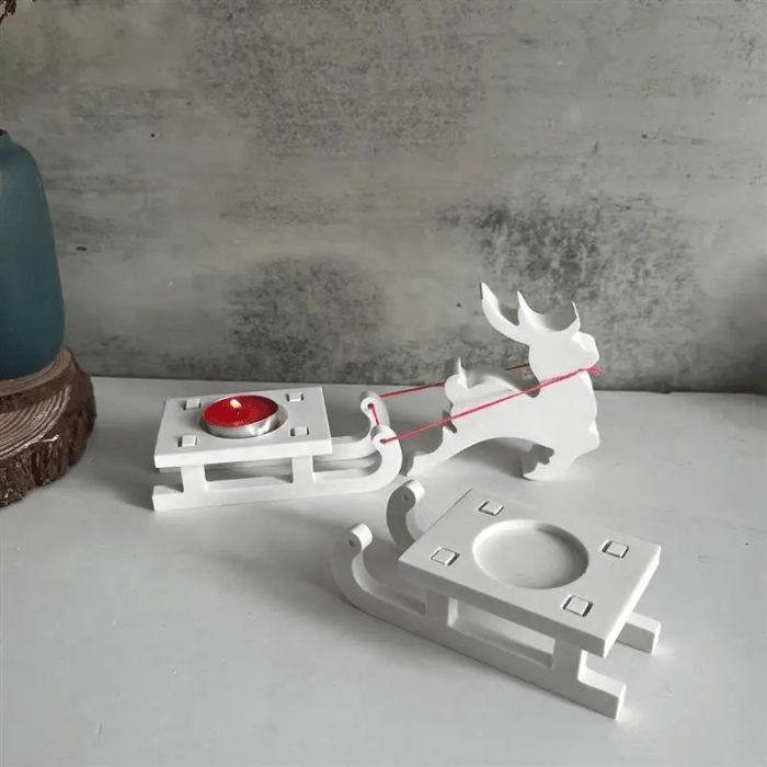 White Christmas reindeer and sleigh candle holder set for festive decoration.