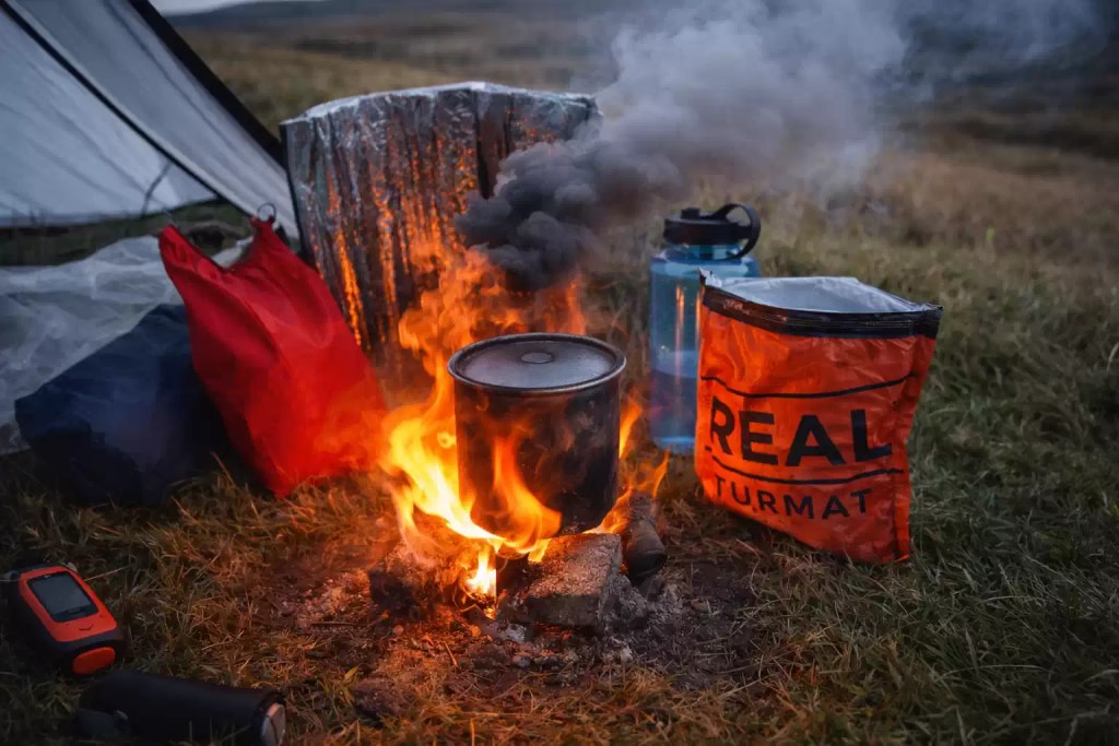 Camping stove cooking hot meals inside tent during winter camping
