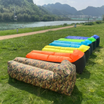 Folded air sofa in its compact travel carry bag.