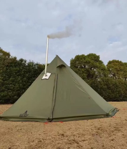 The Ultra Stove Tent with a wood stove chimney venting through the roof in a snowy camp.