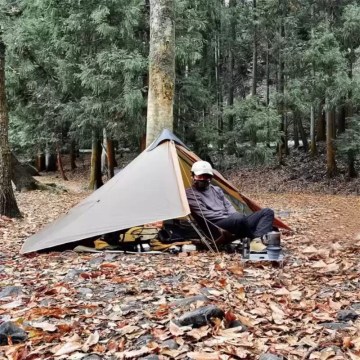 Ultralight trekking shelter used for wild camping in UK woodland.