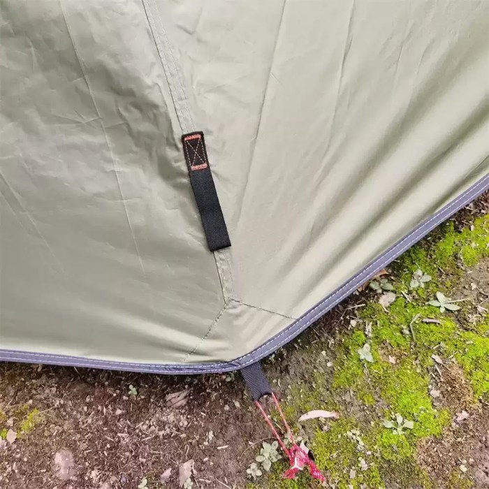 Height Adjustable Tipi Hot Tent for Winter Camping A hunter setting up the tipi hot tent in a dense forest for a hunting trip.