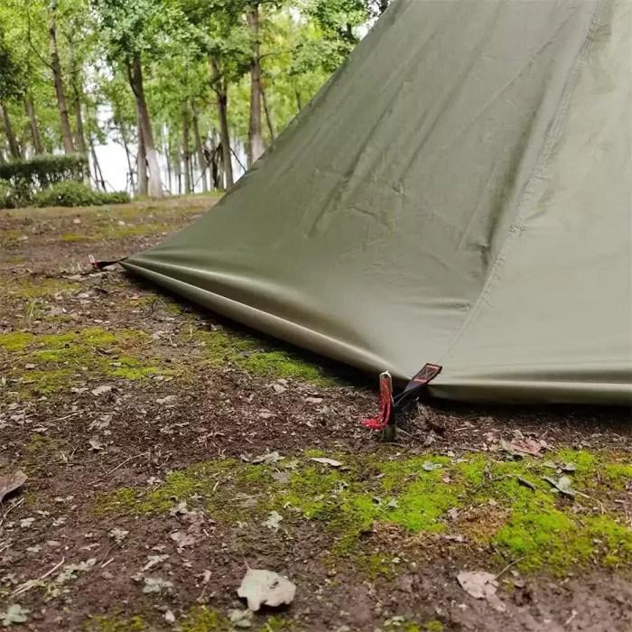 Height Adjustable Tipi Hot Tent for Winter Camping The Ultra Stove Tent with a wood stove chimney venting through the roof in a snowy camp.