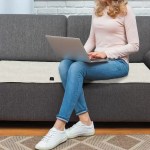 Adjustable temperature mat on grey sofa.