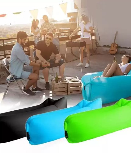 Foldable inflatable sofa chair in green for camping.