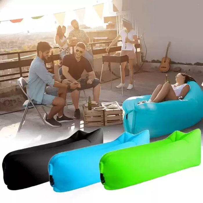 Foldable inflatable sofa chair in green for camping.