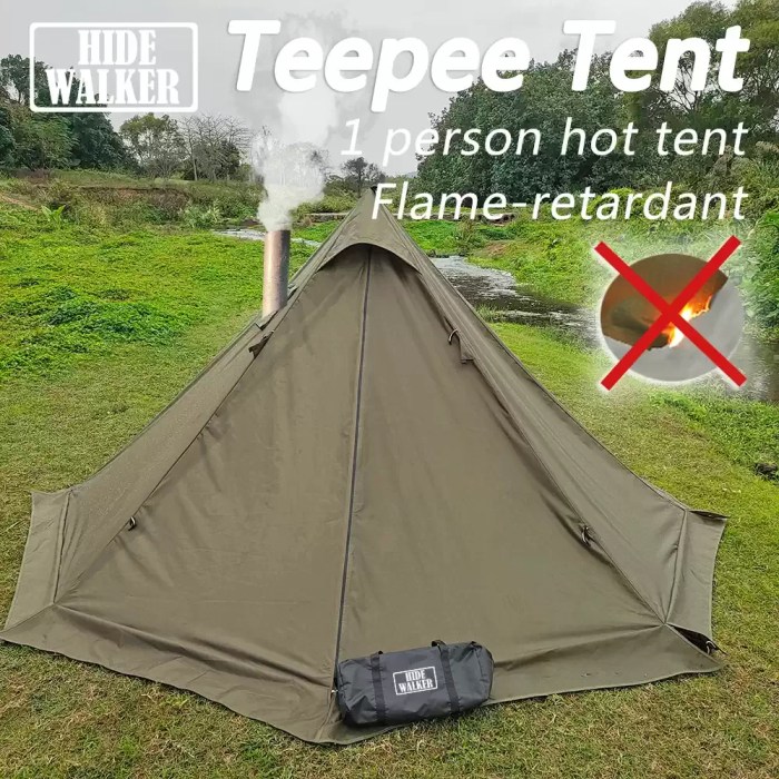 A flame-retardant pyramid hot tent with a stove pipe venting through the roof in a snowy forest.