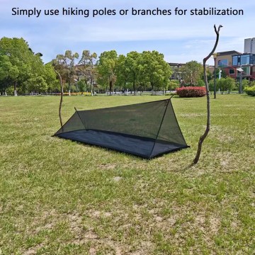 Lightweight bug net tent pitched with hiking poles, ideal for UK camping and outdoor use