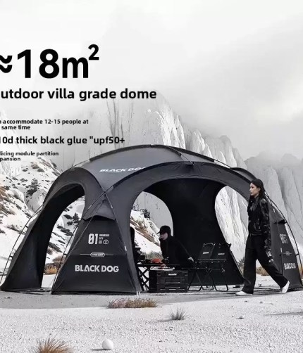 A sleek luxury black glue camping tent set up in a sunny meadow.