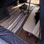 Interior view looking up at the central pole and tall peak of the oversized tent.