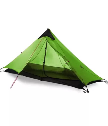 An outdoor ultralight camping tent pitched with a trekking pole on a mountain ridge.