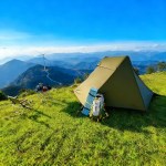 A hiker carrying the compact ultralight bivy tent in its small travel bag.