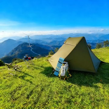 A hiker carrying the compact ultralight bivy tent in its small travel bag.